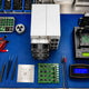Bench layout of Antminer hashboard repair spare parts.