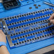 Avalon Canaan 1166 Pro hashboard with Canaan A3206 ASIC chips and modular 17.5V boost module on professional repair workbench — repair guide