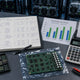 Top-down view of a Bitcoin mining ROI workspace in 2026 with calculator, fleet maintenance ledger, spare hashboard chips and miner runtime metric.