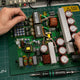 Bitmain APW9+ PSU with dual PFC stages and LLC architecture on repair workbench — repair guide