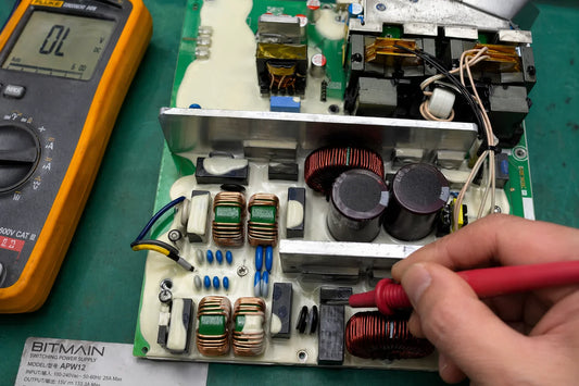 Opened APW12 power supply on repair bench showing internal components — PSU deep dive guide