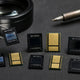 Bitmain ASIC chips arranged for comparison on repair bench — chip generations guide
