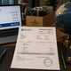 Procurement desk with proforma invoice showing DDP Incoterm, laptop with order summary, globe showing China-to-US shipping route — Incoterms decision guide for mining parts from China