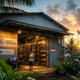 Indonesian Bitcoin mining facility at sunset with Antminer and Whatsminer units fitted with industrial silver silencers, palm trees in foreground — SE Asia mining frontier guide