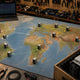 World map on a workshop bench with mining-rig icons placed at major hashrate destinations, dashed migration arrows showing fleet relocation paths.