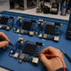 Whatsminer control board on repair bench with microSD firmware card inserted, CB2/CB4/CB6 family lineup and diagnostic tools — Whatsminer control board identification & replacement guide