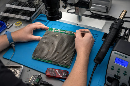 Antminer S19 hashboard with BM1398BB ASIC chips on repair workbench with rework tools — repair guide