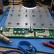 Antminer S19j Pro hashboard on repair workbench with BM1362 ASIC chips and rework tools — repair guide