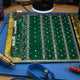 Antminer S19k Pro BHB56902 hashboard on repair workbench with BM1366 ASIC chips and rework tools — repair guide