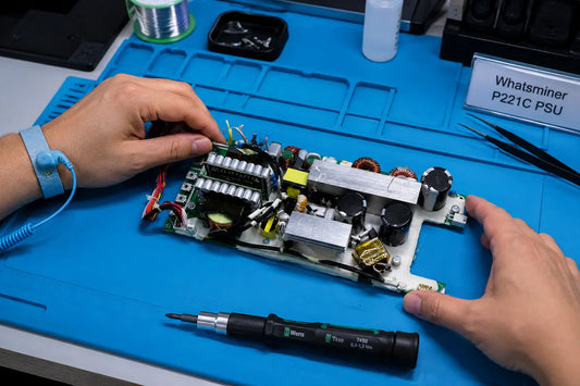 Whatsminer P221C PSU with M6 copper bar output and modular control ICs on professional repair workbench — repair guide